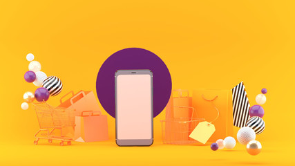 .Smartphone to enter content surrounded by shopping bags, shopping carts on an orange background.-3d rendering.