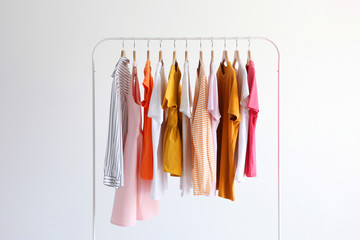 fashion clothes on a stand in a light background indoors. place for text