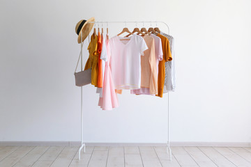 Wall Mural - fashion clothes on a stand in a light background indoors. place for text
