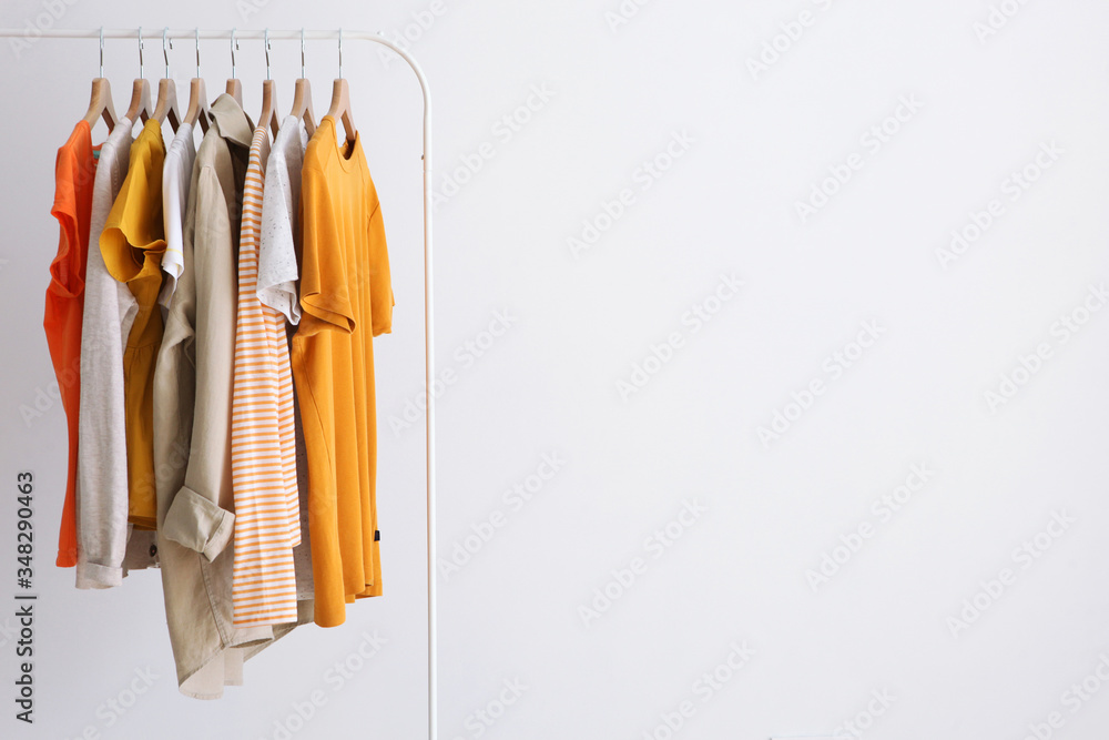 fashion clothes on a stand in a light background indoors. place for text
 - obrazy, fototapety, plakaty 