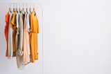 fashion clothes on a stand in a light background indoors. place for text
