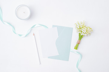 Wall Mural - Mockup white wedding invitation and envelope with white flowers on a white background