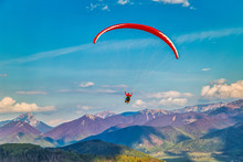 Flying Paraglider From The Stranik Hill Over The Mountainous Landscape Of The Zilina Basin In The North Of Slovakia..Mala Fatra National Park In The Background, Slovakia, Europe..