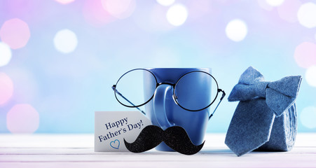 Celebration background on Happy Father day. Creative breakfast with funny face from cup of coffee, eyeglasses and mustache. Greeting card for daddy.