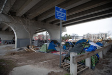 Homeless Under A Bridge With Sign