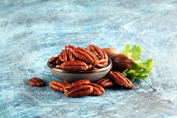 Canvas Print - Tasty Pecan nuts on a rustic table.