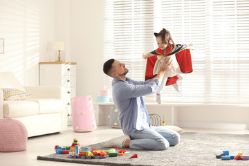 Wall Mural - Father playing with his child at home