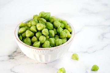 green chickpeas or garbanzo beans in a bowl with copy space