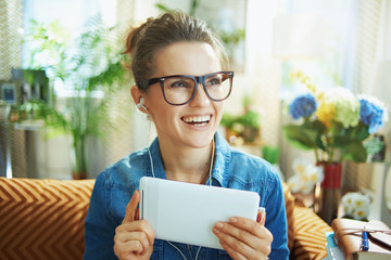 smiling woman with white headphones and tablet PC study online