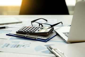Wall Mural - Financial Report- Business Accounting money stack Concept Business Man Using Calculator graph discussion and analysis data charts and graphs