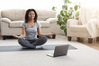 © Prostock-studio - Happy African American Woman Meditating In Front Of Laptop At Home