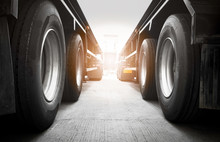 Semi Trailer Trucks On Parking  At Warehouse. Big Rig Semi Truck Wheels Tires. Auto Service Shop. Shipping Trucks. Lorry Tractor. Industry Freight Truck Logistics Cargo Transport.	