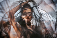 Beautiful Young Woman Covered With Fabric And Blindfolded. Double Exposure Concept