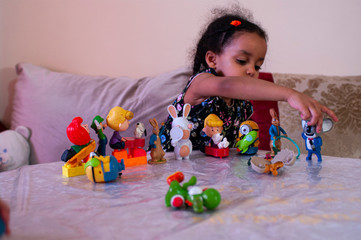 little girl playing with toys