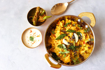 Dal khichadi/Masala Khichdi/daal khichdi tadka is a healthy Indian recipe made of mixed Lentils & rice combined with spices & vegetables. Served with Curd or Yogurt, Papad & chili pickle. Copy Space