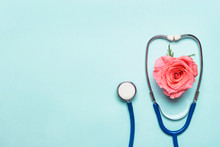 Stethoscope And Beautiful Rose Heart On Blue Background. Thank You Doctor And Nurse Day Concept