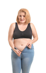 Wall Mural - Troubled overweight woman on white background. Weight loss concept