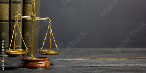 Law concept - Open law book with a wooden judges gavel on table in a courtroom or law enforcement office isolated on white background. Copy space for text