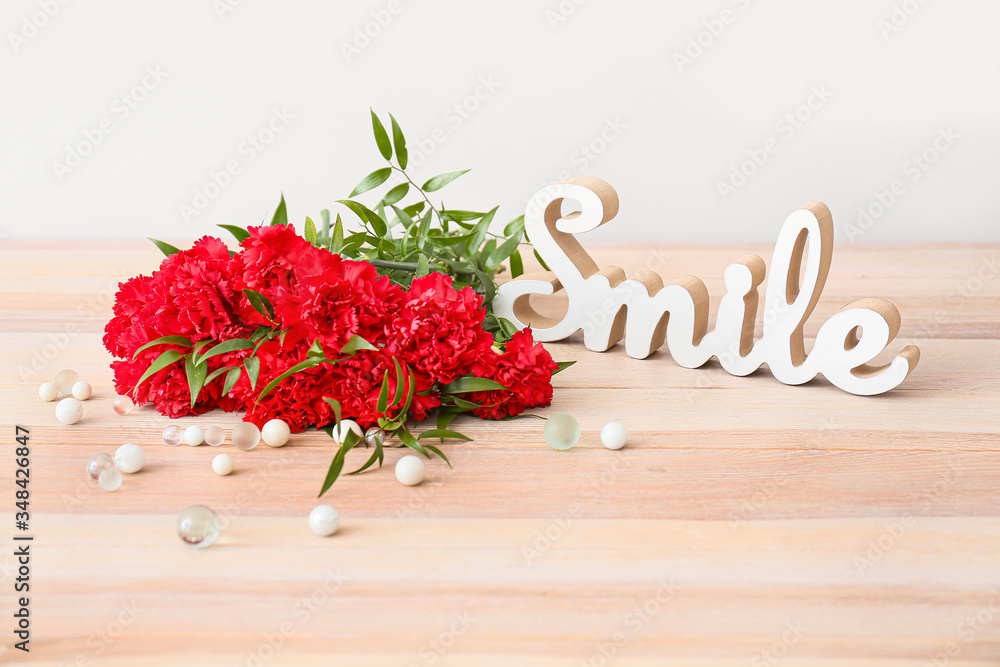 Bouquet of beautiful flowers on table against light background
