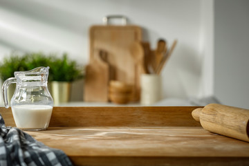 Wall Mural - wooden table in the kitchen with incoming morning sunlight with free space for an advertising produc