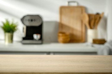 Wall Mural - Wooden table in the kitchen with incoming morning sunlight with free space for an advertising product