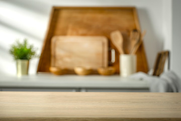 Wall Mural - wooden table in the kitchen with incoming morning sunlight with free space for an advertising produc