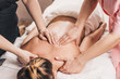 © andrey gonchar - Treatment of pain in the spine with massage - hands of a masseur on the patient back - manual therapy
