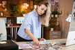 © DC Studio - Caucasian female designer woman in creative office working on her designs.