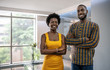 © JonoErasmus - Two confident young African businesspeople standing in a modern