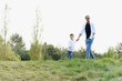 © Serhii - father and son have fun together in nature. Father and son playing. People having fun outdoors. Concept of friendly family.