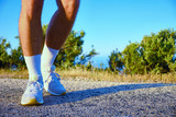 Fototapeta Sport - legs of man during morning jogging in the countryside