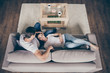 © deagreez - High angle above view photo of pretty charming lady homey guy couple relaxing comfy couch stay home affectionate quarantine hugging glad together living room indoors