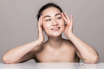 Wall Mural - Closeup portrait of young woman face skin care with cosmetics isolated on gray background