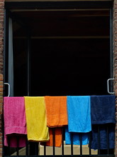 Close-up Of Colorful Towels Drying On Railing In Balcony
