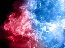 Red And Blue Colorful Smoke On Dark Background.