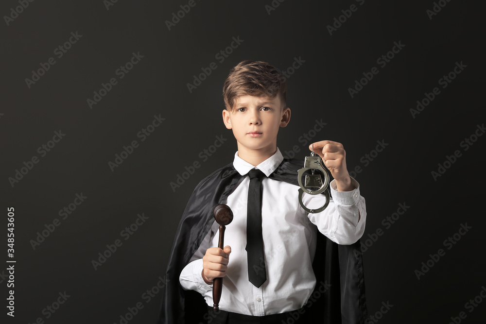 Portrait of little judge on dark background