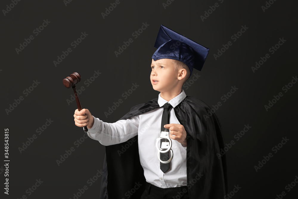 Portrait of little judge on dark background
