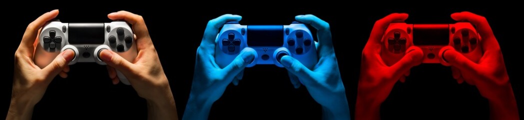 Set of hands holding video game gamepad in neon lights isolated on a black