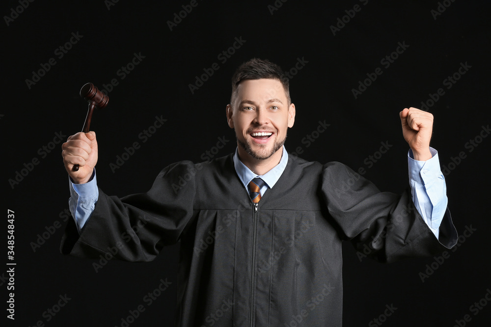 Happy male judge on dark background