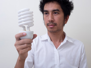 man holding energy saving bulb for lamp