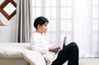 © Gengwit - Attractive asian male working with computer laptop at home. Work from home concept.