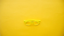 Yellow Glasses On A Yellow Background