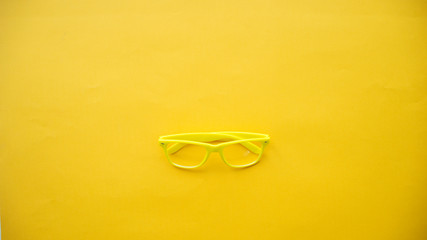 Wall Mural - yellow glasses on a yellow background