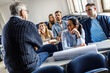 © BalanceFormCreative - College students listen to professor's lecture in class room.