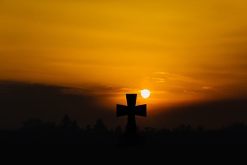 The concept of Jesus Christ: the cross at sunset.