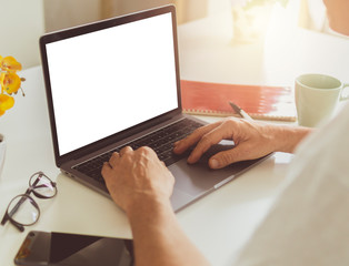 Close up of adult man hands typing on laptop - Man using notebook at home with blank mock up white empty screen - computer mockup copyspace display for shopping online, job search