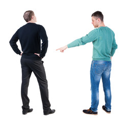 Back view of two man in sweater pointing.