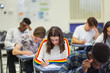 © Chris Ryan/Caia Image - Focused high school girl student taking exam at desk in computer