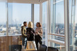 © Tom Merton/Caia Image - Business people talking at sunny highrise office window
