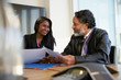 © Chris Ryan/Caia Image - Smiling business people discussing paperwork in conference room meeting